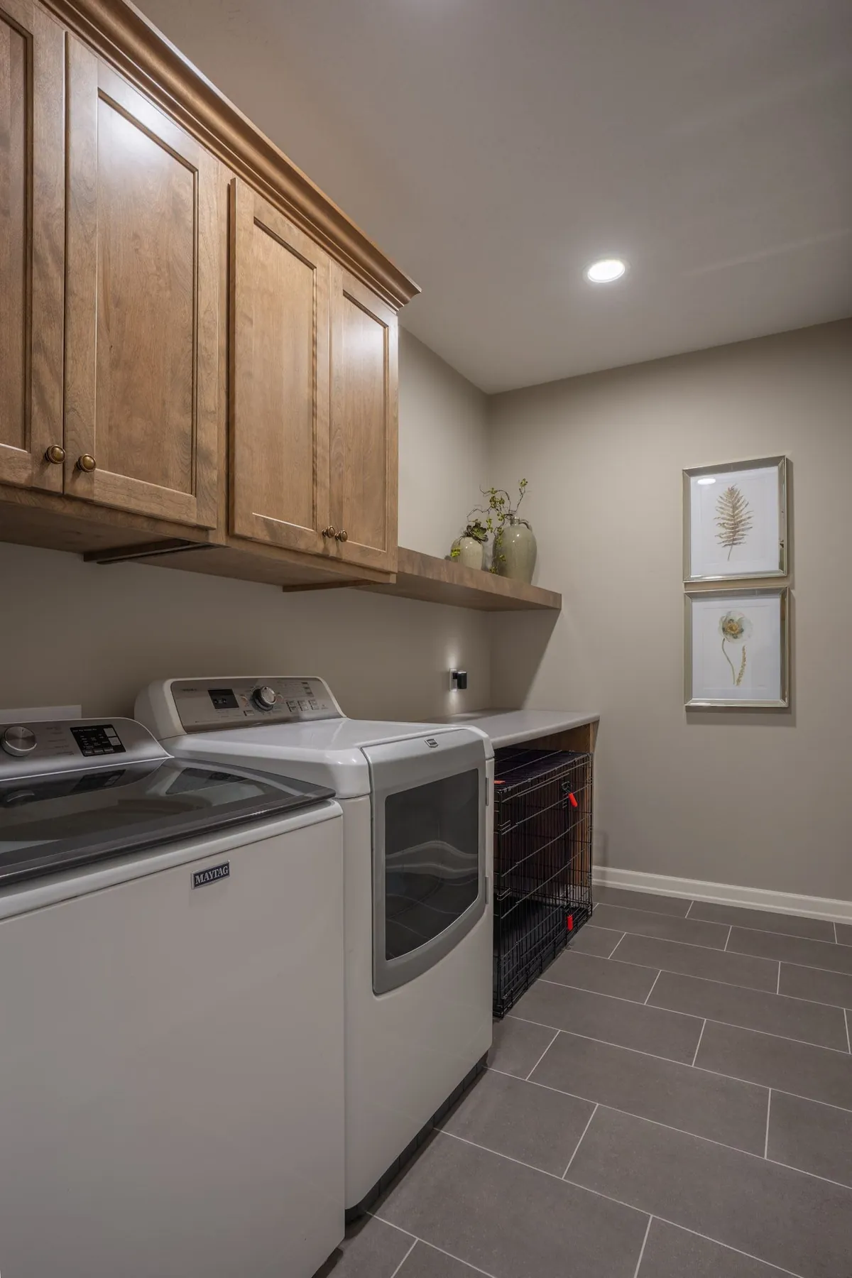 Laundry room with cabinetry and tile floor, real estate photography Sioux Falls SD