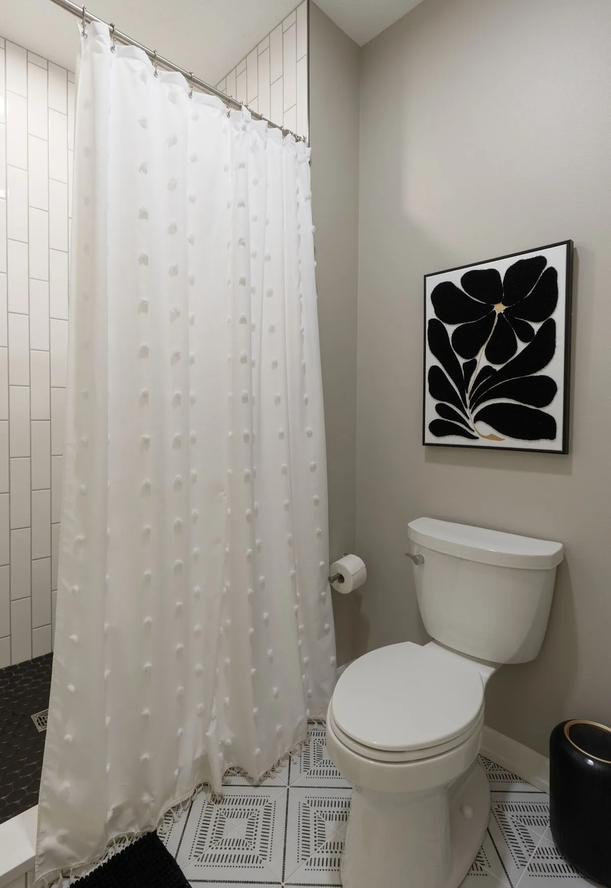 Bathroom with tub-shower and patterned floor, real estate photography Sioux Falls SD