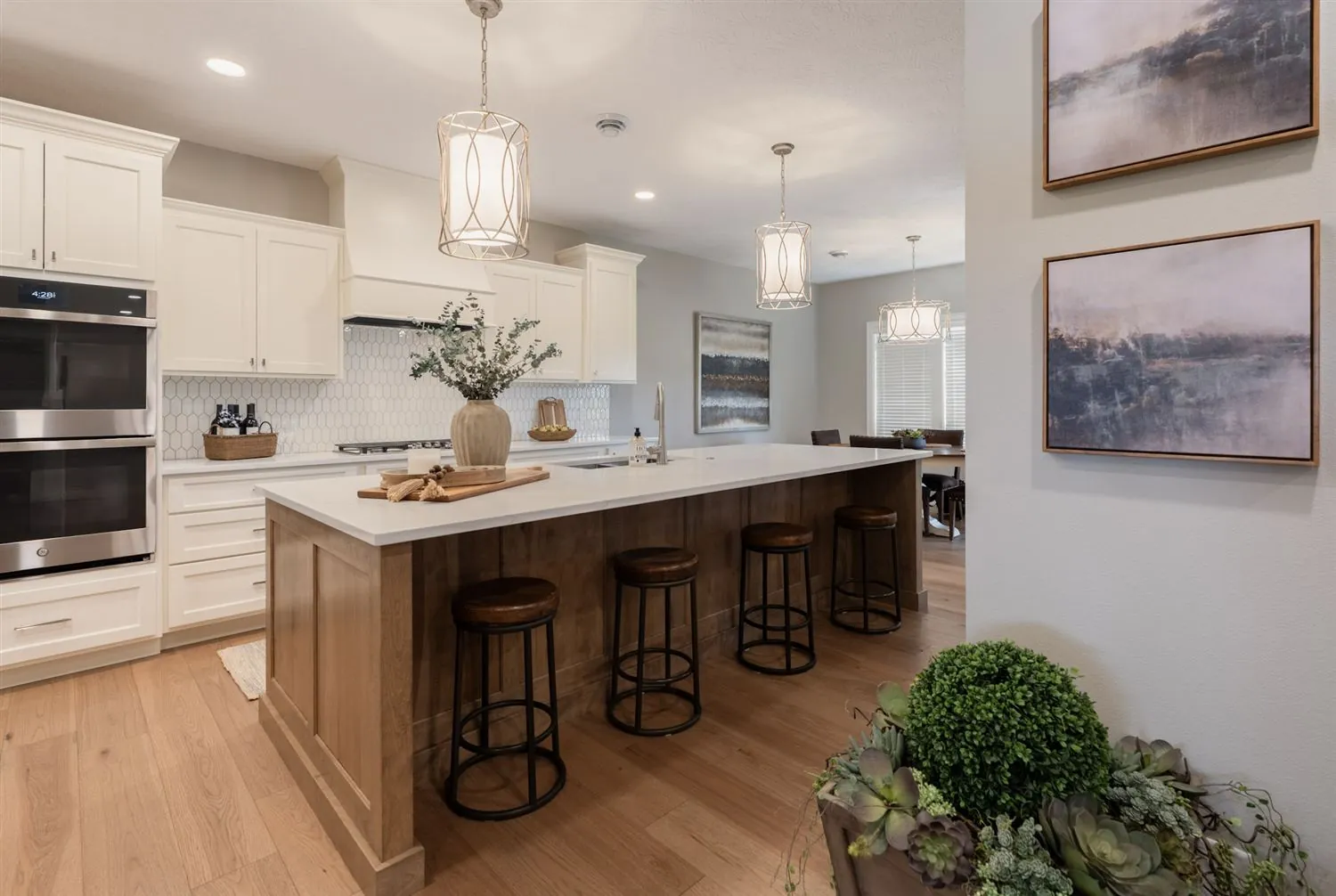White kitchen with wood island and bar stools, real estate photography Sioux Falls SD