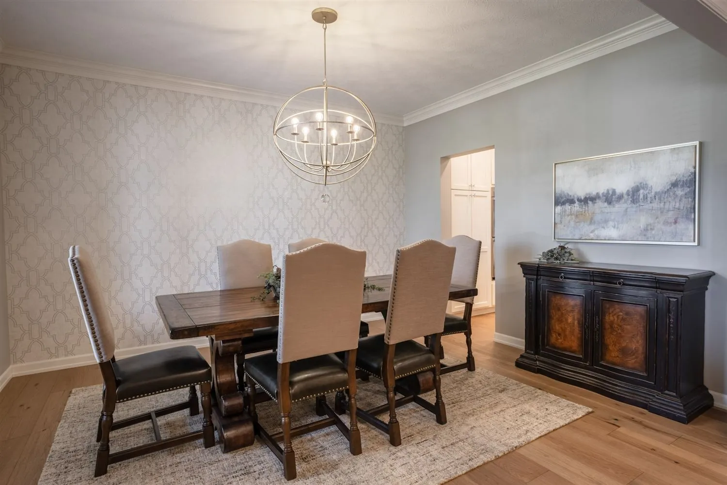 Formal dining room with chandelier and upholstered chairs, real estate photography Sioux Falls SD