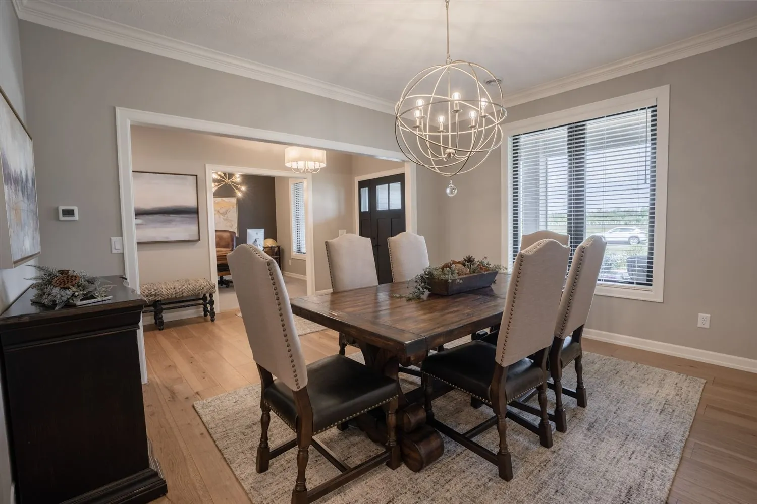 Dining room with long table and orb chandelier, real estate photography Sioux Falls SD