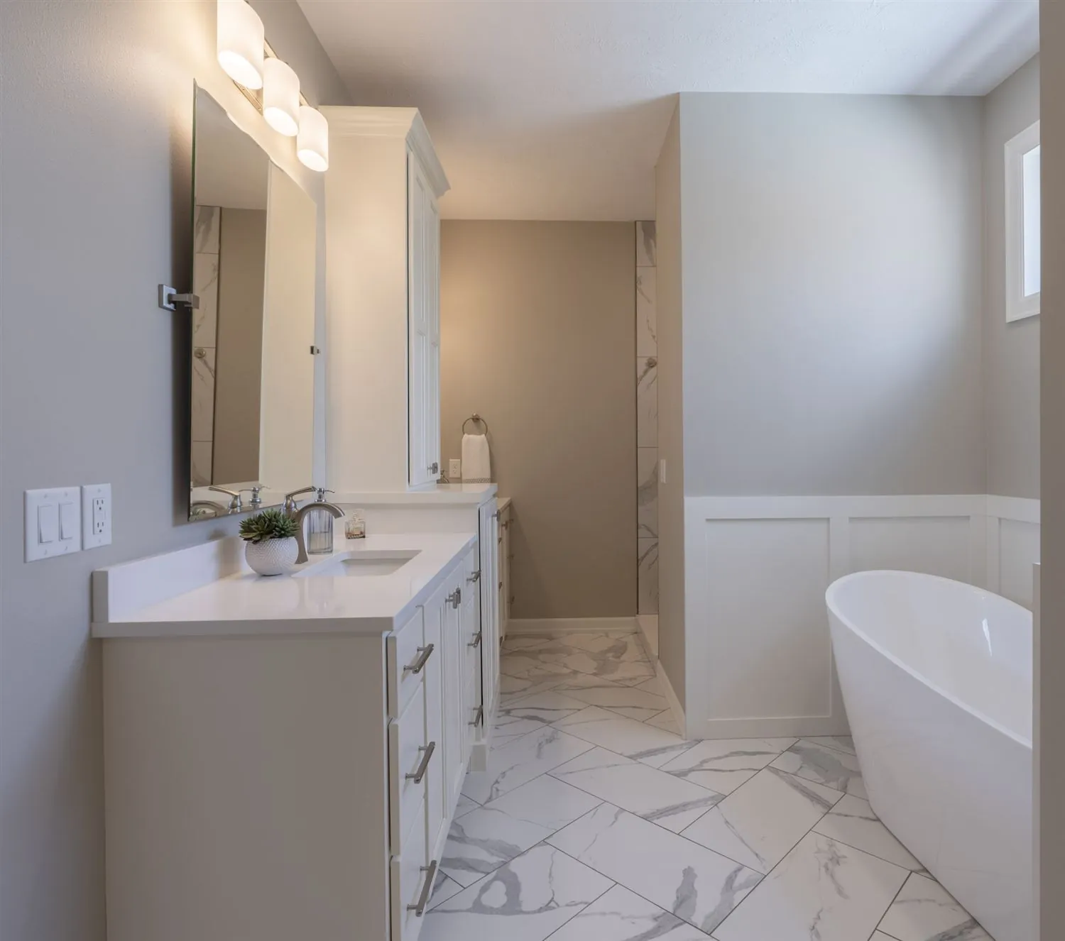 Freestanding soaking tub in a marble bathroom, real estate photography Sioux Falls SD