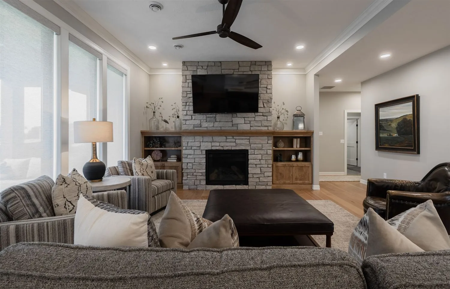 Living room with stone fireplace and mounted TV, real estate photography Sioux Falls SD