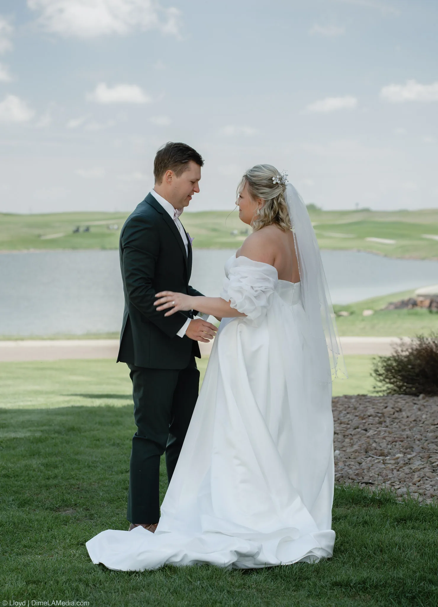 Bride and groom holding hands and talking quietly to each other after the first look