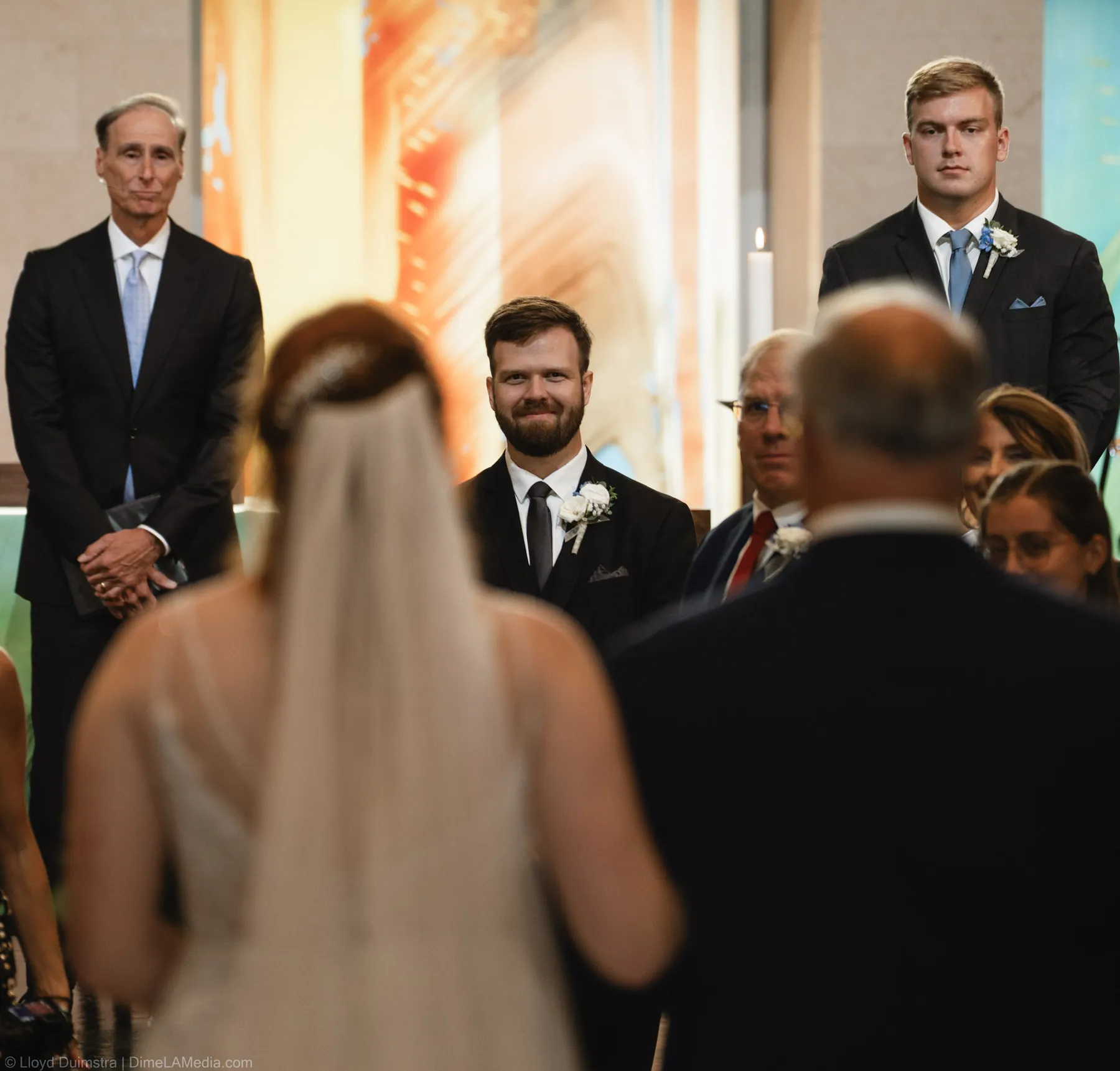 Bride at the altar framed by colorful stained glass